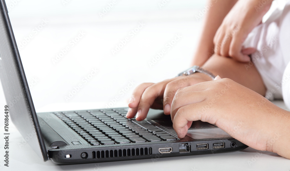 hand on laptop keyboard