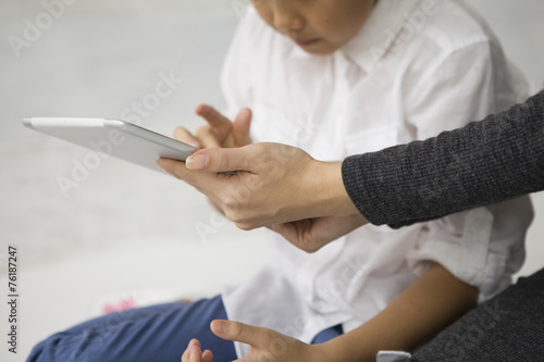 Mother and daughter looking at the electronic tablet