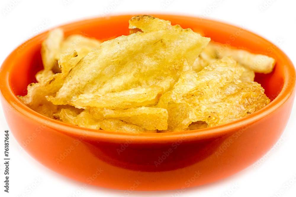 Thick rippled potato chips in bowl isolated