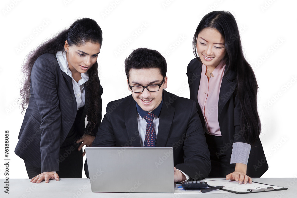 Business leader using laptop with his employees Business leader using laptop with his employees