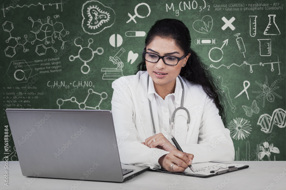 Doctor working with laptop and clipboard Doctor working with laptop and clipboard