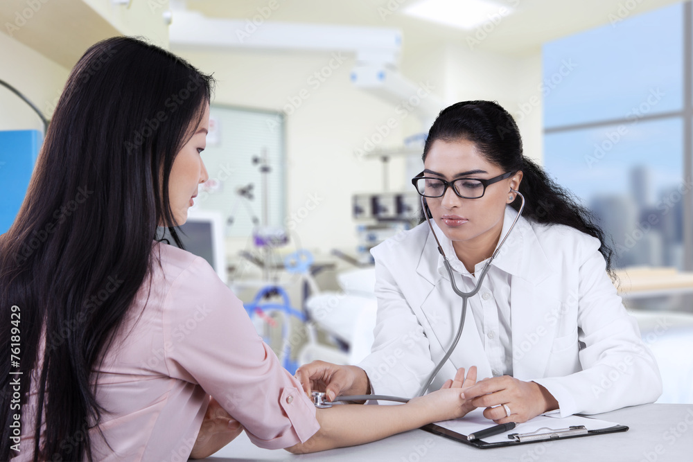 Female patient checked by doctor