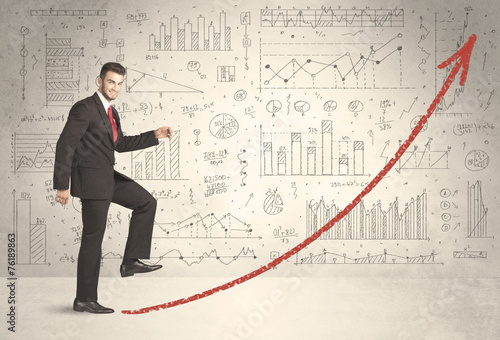 Business man climbing on red graph arrow concept