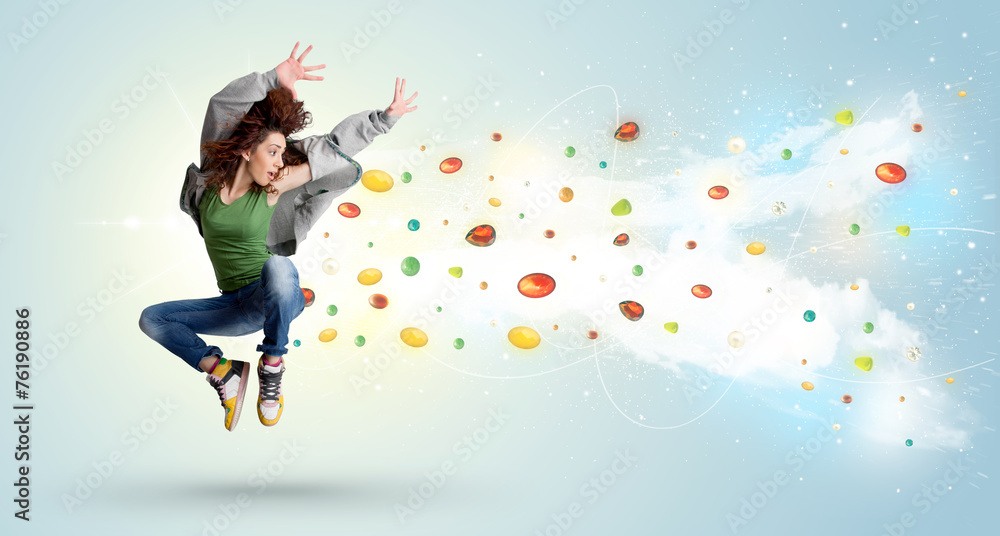 Beautiful woman jumping with colorful gems and crystals on the b Beautiful woman jumping with colorful gems and crystals on the b