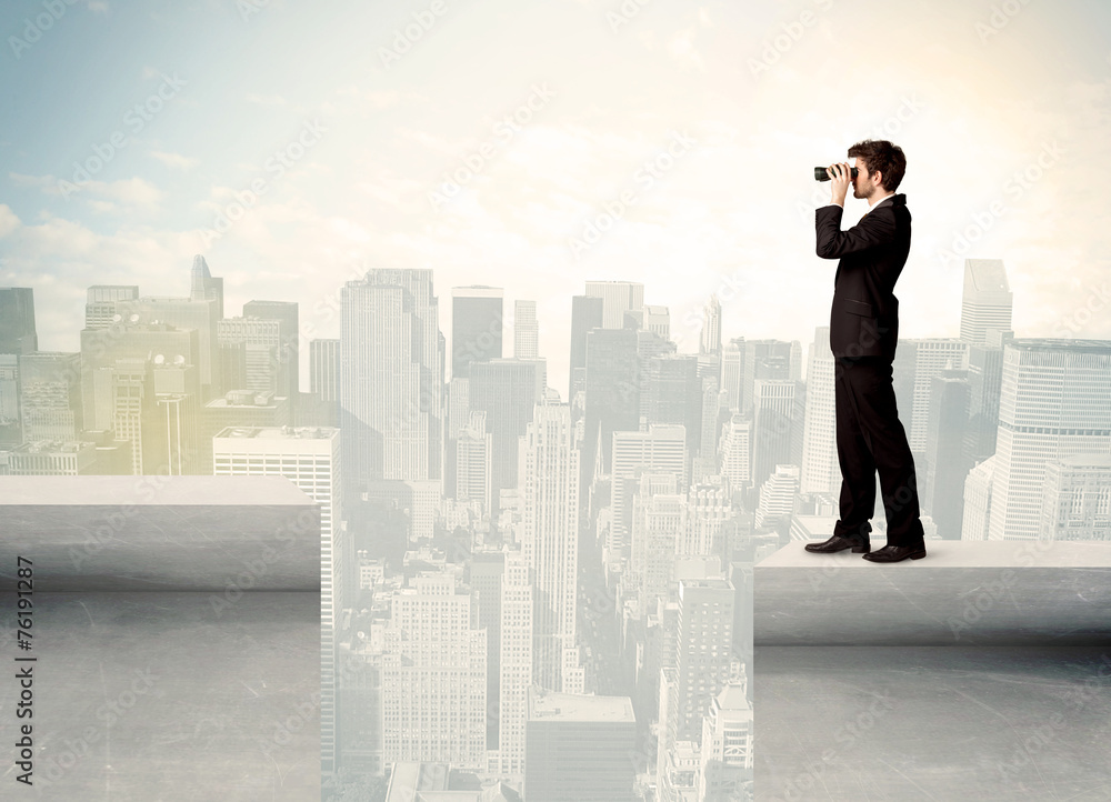 Businessman standing on the edge of rooftop Businessman standing on the edge of rooftop