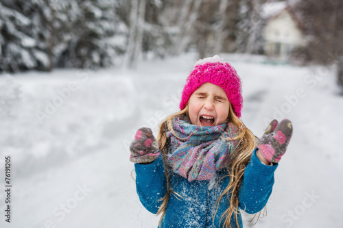 Little girl joking screaming in the winter