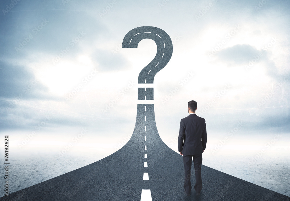 © ra2 studio - Business person lokking at road with question mark sign © ra2 studio - Business person lokking at road with question mark sign