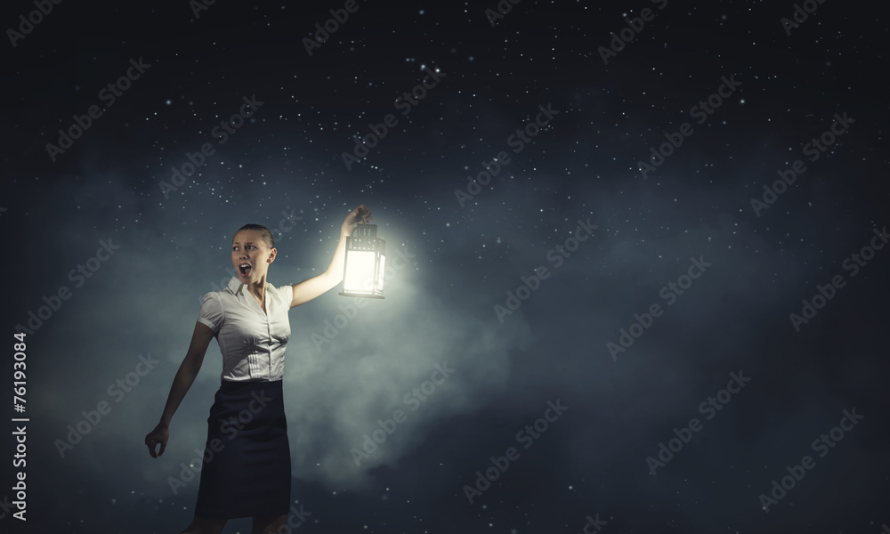 Businesswoman with lantern
