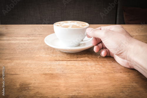 A cup of coffee with man hand