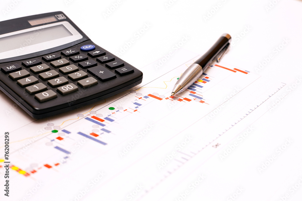 Business abstract - calculator and elegant pen on finance chart. Business abstract - calculator and elegant pen on finance chart.