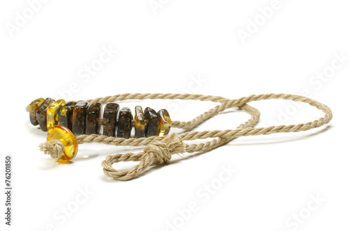 Raw fashion amber necklace isolated on the white background
