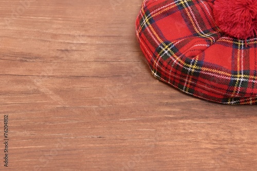 Traditional Scottish Red Tartan Bonnet on Wood Board