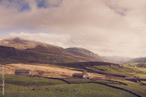Fields and farmer cottages in the mountains. Rural landscape