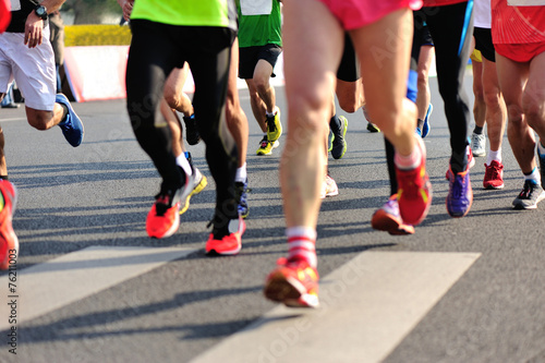  marathon athletes legs running on city road © lzf