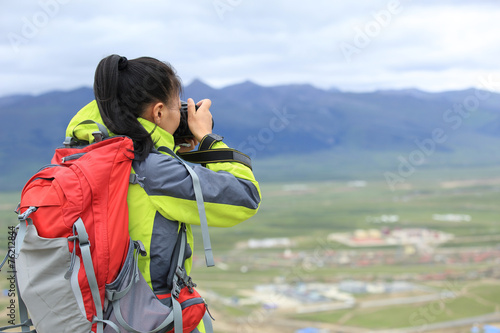 young woman photographer taking photo outdoor © lzf
