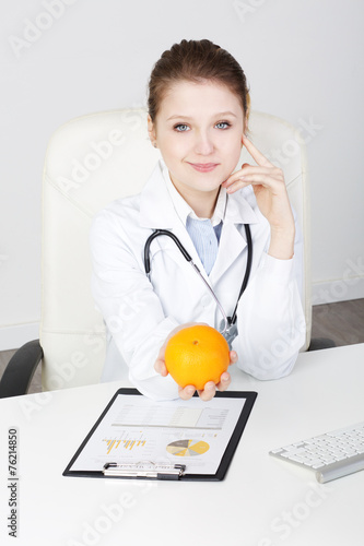 Woman Doctor Recommanding An orange photo