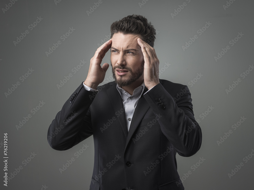 Businessman with headache head in hands Businessman with headache head in hands