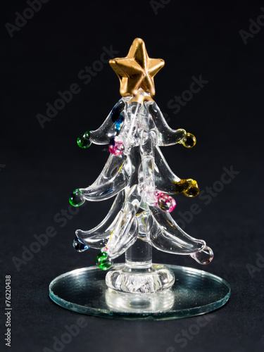 glass christmas tree over black background