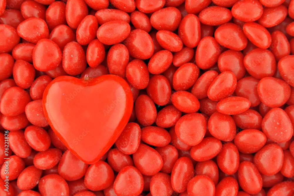Fototapeta premium One Big Candy Heart on Top of Small Valentine Candies