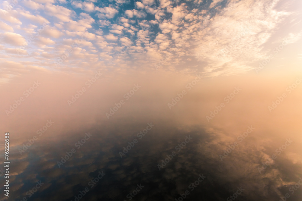 misty morning on the river and clouds reflected in water misty morning on the river and clouds reflected in water