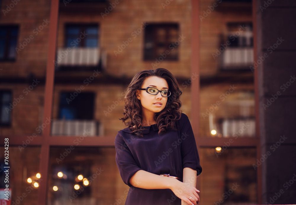 pretty young woman with glasses posing