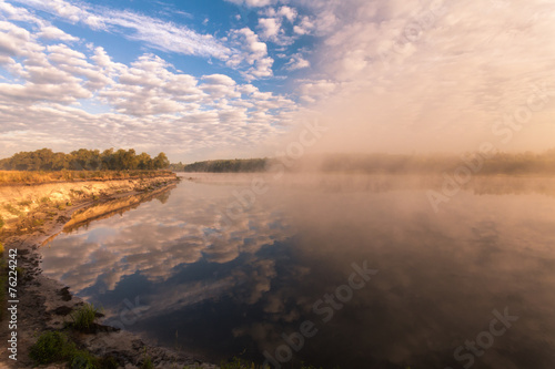 misty morning on the river and clouds reflected in water © Dmytro Kosmenko
