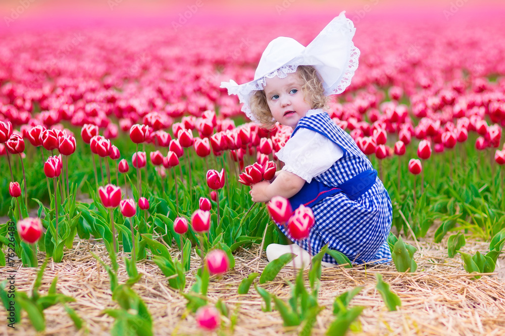 Dutch girl in tulip field in Holland Dutch girl in tulip field in Holland