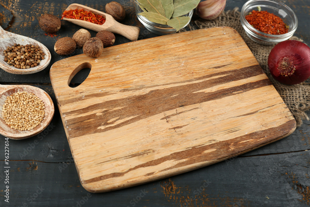 Different spices and herbs with cutting board Different spices and herbs with cutting board