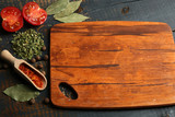 Different spices and herbs with cutting board