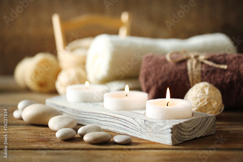 Composition of spa treatment  candles in bowl with water