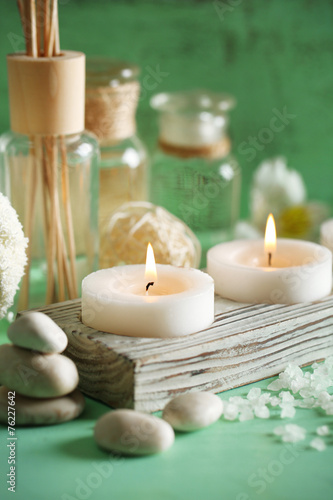 Candles  bottles sea salt and spa stones on wooden background
