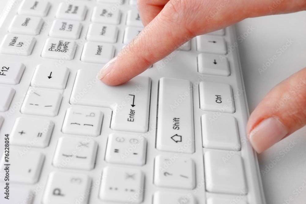 Female hand typing on keyboard, macro view Female hand typing on keyboard, macro view