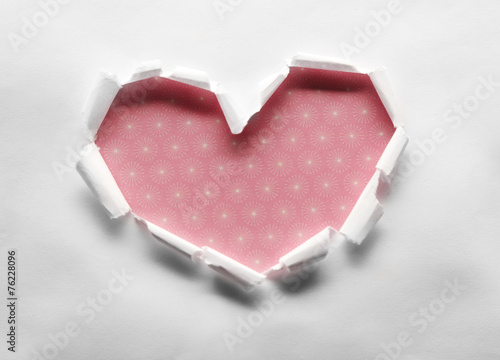 Torn paper heart over colorful background