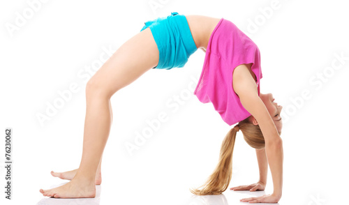Young healthy girl doing stretching exercises
