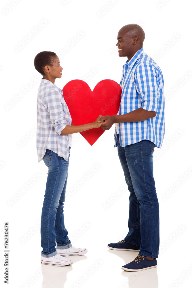 couple holding hands and paper heart symbol couple holding hands and paper heart symbol