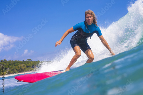 Surfer girl on the wave, Indonesia.