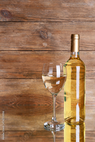 White wine on table on wooden background