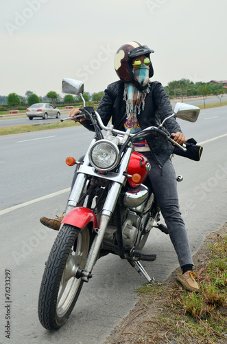 Fototapeta Woman riding chopper motorcycle on the way with Distance signs