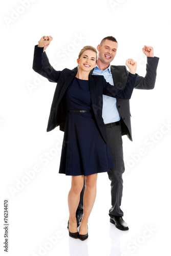 Victorious business couple with hands up