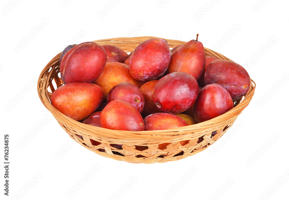 Plum in a wattled basket, isolated on a white background Plum in a wattled basket, isolated on a white background