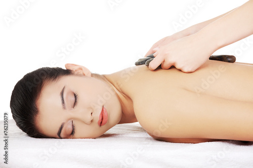 Girl on a stone therapy, hot stone massage