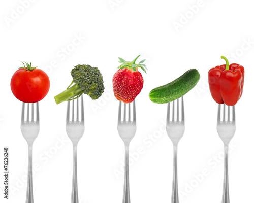 Healthy diet, organic food on forks with vegetables and berries.