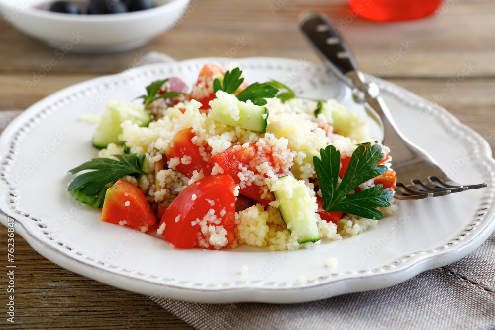 Salad with arabic couscous and vegetables on a white plate Salad with arabic couscous and vegetables on a white plate