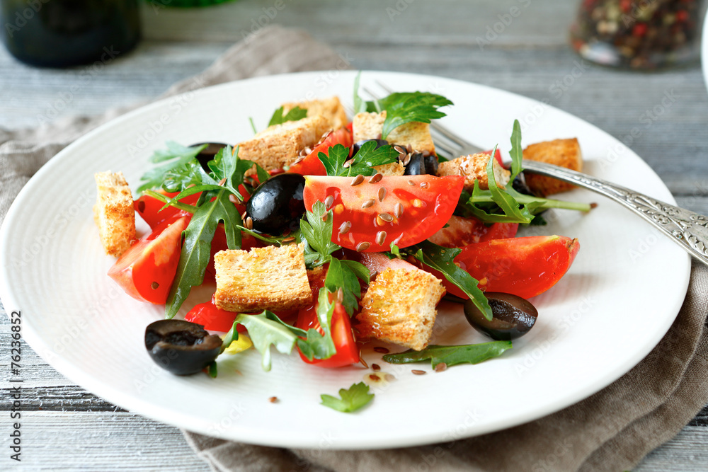 Summer salad with tomatoes and arugula, olives
