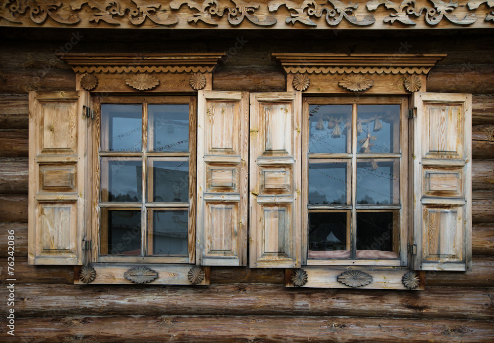 Windows with shutters, patterned on the wall of the old wooden h Windows with shutters, patterned on the wall of the old wooden h