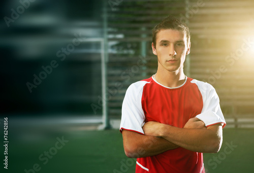 portrait of soccer player with his arms crossed in training