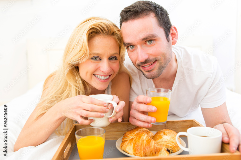 Portrait of a couple having breakfast in bed Portrait of a couple having breakfast in bed