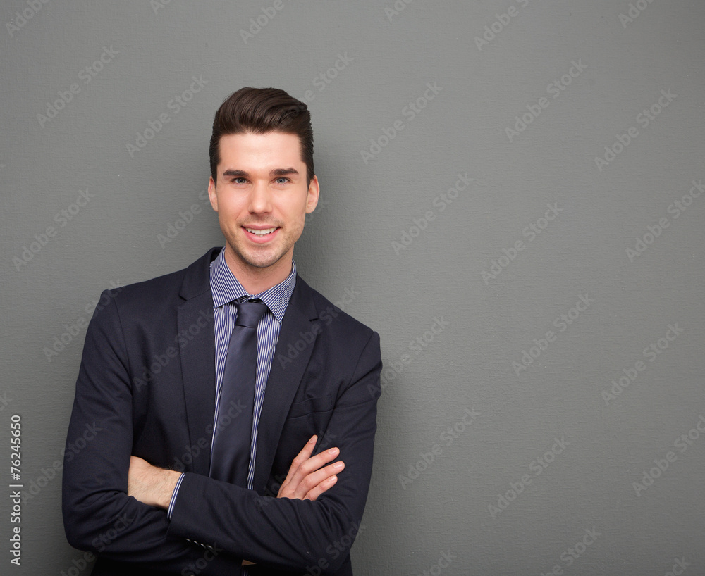 Handsome young business man smiling with arms crossed Handsome young business man smiling with arms crossed