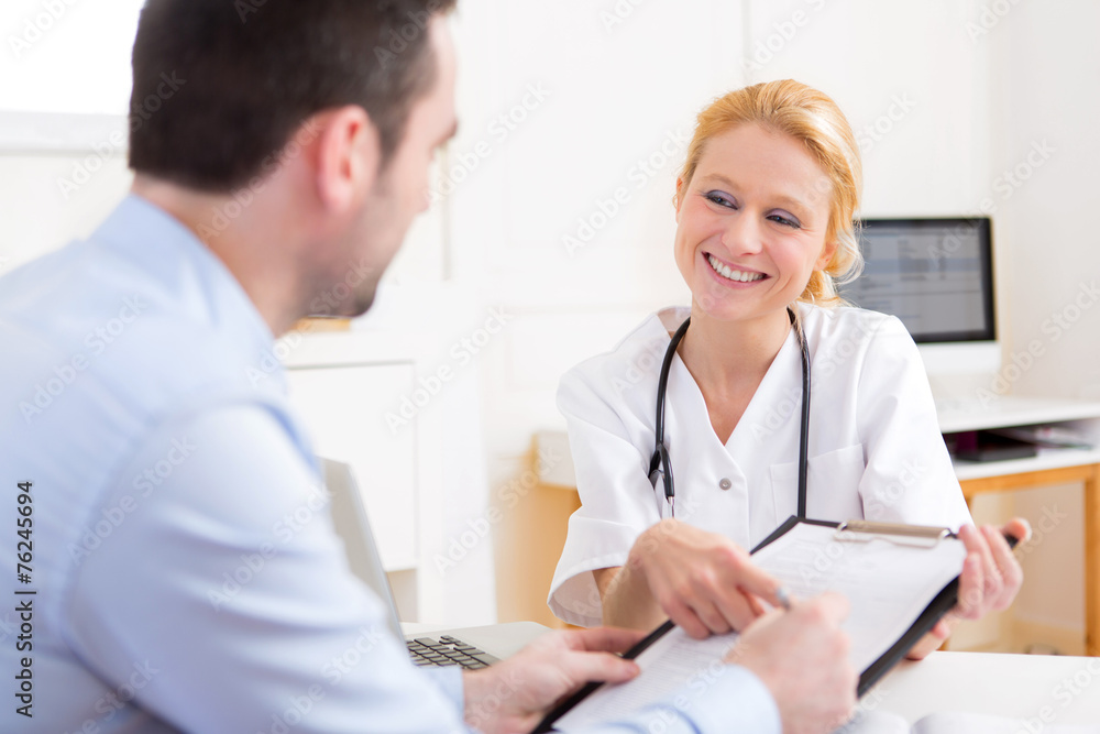 Patient signing the document of a young attractive doctor Patient signing the document of a young attractive doctor