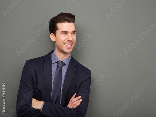 Smiling business man standing with arms crossed